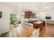 Bright open concept kitchen and dining area with island, stainless steel appliances, wooden table and chairs at 1309 Belgian Draft Dr, Mount Pleasant, SC 29466
