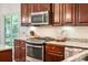 The kitchen features stainless steel appliances, granite countertops, wooden cabinets, and white subway tile backsplash at 1309 Belgian Draft Dr, Mount Pleasant, SC 29466