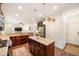 Open concept kitchen with center island, granite countertops, stainless steel appliances, and dark wooden cabinets at 1309 Belgian Draft Dr, Mount Pleasant, SC 29466