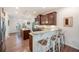 Modern kitchen boasts granite countertops, bar stool seating, stainless steel appliances, and dark wooden cabinets at 1309 Belgian Draft Dr, Mount Pleasant, SC 29466