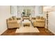 Stylish living room features hardwood floors, white walls, a neutral-toned rug, and comfortable seating at 1309 Belgian Draft Dr, Mount Pleasant, SC 29466