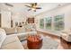 Spacious living room features hardwood floors, comfortable seating, and great natural light, with a glimpse into the kitchen at 1309 Belgian Draft Dr, Mount Pleasant, SC 29466