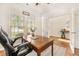 Well-lit office features hardwood floors, a wooden desk, an ergonomic chair, and French doors to the home interior at 1309 Belgian Draft Dr, Mount Pleasant, SC 29466