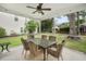 Covered screened in patio with outdoor dining area set amongst lush greenery and blue sky at 1309 Belgian Draft Dr, Mount Pleasant, SC 29466