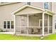 Screened in porch has a ceiling fan and a dining set, ideal for relaxing and entertaining at 1309 Belgian Draft Dr, Mount Pleasant, SC 29466