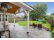 Expansive backyard featuring a stone firepit, playset, and covered patio area at 1328 Lark Ln, Hanahan, SC 29410