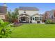 Expansive backyard boasting a covered patio, fire pit, manicured lawn, and mature landscaping for outdoor enjoyment at 1328 Lark Ln, Hanahan, SC 29410