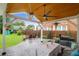 Inviting covered patio with outdoor seating, grill, and view of the landscaped backyard with fire pit at 1328 Lark Ln, Hanahan, SC 29410