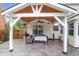 Charming covered patio area with a ceiling fan, outdoor seating, and serene backyard views at 1328 Lark Ln, Hanahan, SC 29410