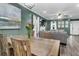 Bright dining area displaying a wooden table set, chandelier, and seamless flow to living room at 1328 Lark Ln, Hanahan, SC 29410