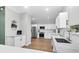 Modern kitchen featuring white cabinets, stainless steel appliances, and wood flooring at 1328 Lark Ln, Hanahan, SC 29410