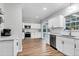 White kitchen cabinets and stainless steel appliances, seamlessly connected to the living room at 1328 Lark Ln, Hanahan, SC 29410