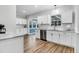 Bright kitchen featuring stainless steel appliances, white cabinets and wood flooring at 1328 Lark Ln, Hanahan, SC 29410