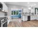 Bright kitchen features white cabinets, modern appliances, and an adjacent sunroom at 1328 Lark Ln, Hanahan, SC 29410