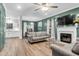 Spacious living room boasts wood floors, fireplace, and lots of natural light at 1328 Lark Ln, Hanahan, SC 29410