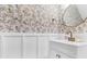 Stylish powder room exhibiting modern fixtures, a round mirror, and decorative wallpaper at 1328 Lark Ln, Hanahan, SC 29410