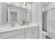Bright bathroom with a double sink vanity, quartz countertop, large mirror, and a tiled walk-in shower with glass door at 138 Brown Swiss Cir, Summerville, SC 29483