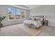 Comfortable bedroom with large windows, tray ceiling, neutral tones, and stylish furnishings, creating a serene retreat at 138 Brown Swiss Cir, Summerville, SC 29483