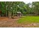Tranquil fenced backyard with a shed, coop, and a peacock, ideal for nature enthusiasts at 1384 Tibwin Rd, McClellanville, SC 29458
