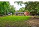 Expansive backyard with well-maintained lawn, quaint cottage, shed, RV, and mature trees at 1384 Tibwin Rd, McClellanville, SC 29458