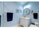 Stylish bathroom featuring a modern vanity, round mirror, and trendy light fixture at 1384 Tibwin Rd, McClellanville, SC 29458