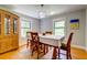Charming dining room with hardwood floors, large windows, and a decorative chandelier at 1384 Tibwin Rd, McClellanville, SC 29458