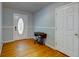 Inviting entryway with hardwood floors, white door and trim, and classic decor at 1384 Tibwin Rd, McClellanville, SC 29458
