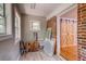 Hallway space with a window and doorway leading to a room with a sliding barn door at 1384 Tibwin Rd, McClellanville, SC 29458