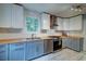 Bright kitchen with modern appliances, two-tone cabinets, and butcher block countertops at 1384 Tibwin Rd, McClellanville, SC 29458