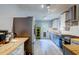 Bright kitchen boasts stainless steel appliances, butcher block countertops, and stylish gray cabinets at 1384 Tibwin Rd, McClellanville, SC 29458