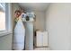 Practical laundry space featuring a sink, ironing board, and storage, combining functionality with simplicity at 1384 Tibwin Rd, McClellanville, SC 29458