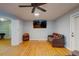 Living room features hardwood floors, a ceiling fan, and a flat-screen television at 1384 Tibwin Rd, McClellanville, SC 29458