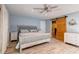 Serene bedroom with a ceiling fan, en suite bathroom, and sliding barn door at 1384 Tibwin Rd, McClellanville, SC 29458
