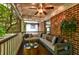 Cozy screened porch featuring a comfortable seating area, brick wall and lovely view of the outdoors at 1384 Tibwin Rd, McClellanville, SC 29458