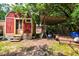 Cozy red shed with a covered storage area, perfect for outdoor projects and equipment at 1384 Tibwin Rd, McClellanville, SC 29458