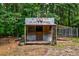 Rustic shed featuring a unique chicken coop sign, adding charm to the backyard at 1384 Tibwin Rd, McClellanville, SC 29458