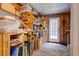 Well-organized storage room with wooden shelves, providing plenty of space for storing materials and equipment at 1384 Tibwin Rd, McClellanville, SC 29458