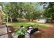 Landscaped backyard featuring a patio seating area and a well-maintained lawn with mature trees at 1417 Downing St, Charleston, SC 29407