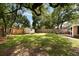 Expansive backyard with lush green lawn, mature trees, and a white storage shed providing ample outdoor space at 1417 Downing St, Charleston, SC 29407
