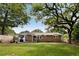 Spacious backyard featuring a well-maintained lawn, brick house, and relaxing outdoor space at 1417 Downing St, Charleston, SC 29407