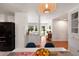 Open-concept dining area featuring wood floors, a custom built-in hutch and a stylish light fixture at 1417 Downing St, Charleston, SC 29407