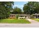 Charming single-story home with a brick facade, well-manicured lawn, and inviting curb appeal at 1417 Downing St, Charleston, SC 29407