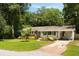 Inviting single-story home featuring brick accents, a carport, and lush landscaping at 1417 Downing St, Charleston, SC 29407