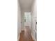 Hallway with hardwood floors and white walls leads to an open bedroom with plenty of light at 1417 Downing St, Charleston, SC 29407