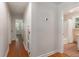 Hallway leading to bathroom with hardwood floors and access to other rooms in the home at 1417 Downing St, Charleston, SC 29407