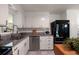 The modern kitchen has granite countertops, stainless steel appliances, and white cabinetry at 1417 Downing St, Charleston, SC 29407
