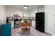 Bright kitchen featuring granite countertops, checkerboard flooring, and stainless steel appliances at 1417 Downing St, Charleston, SC 29407