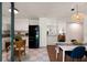 Bright, open concept featuring a black refrigerator and dining area with modern lighting at 1417 Downing St, Charleston, SC 29407