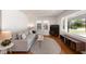 Cozy living area with hardwood floors, a comfortable sofa, and natural light from the windows at 1417 Downing St, Charleston, SC 29407