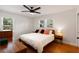 Bedroom with hardwood floors and updated fixtures, including a black ceiling fan at 1417 Downing St, Charleston, SC 29407